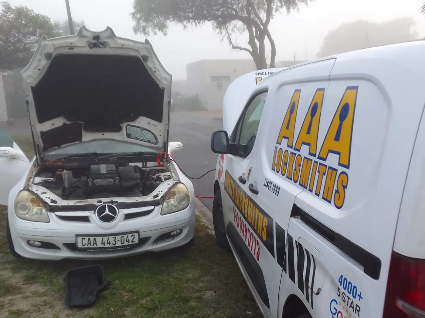 AAA Locksmiths service van assisting a vehicle