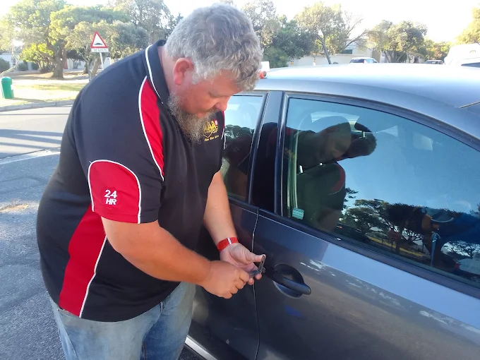 AAA Locksmiths technician opening a vehicle door