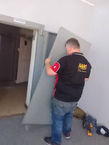 AAA Locksmiths technician working on a commercial door