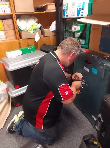 AAA Locksmiths technician working on a business safe