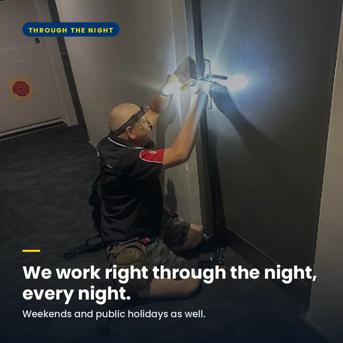 An AAA locksmith working on an apartment door at night by torchlight