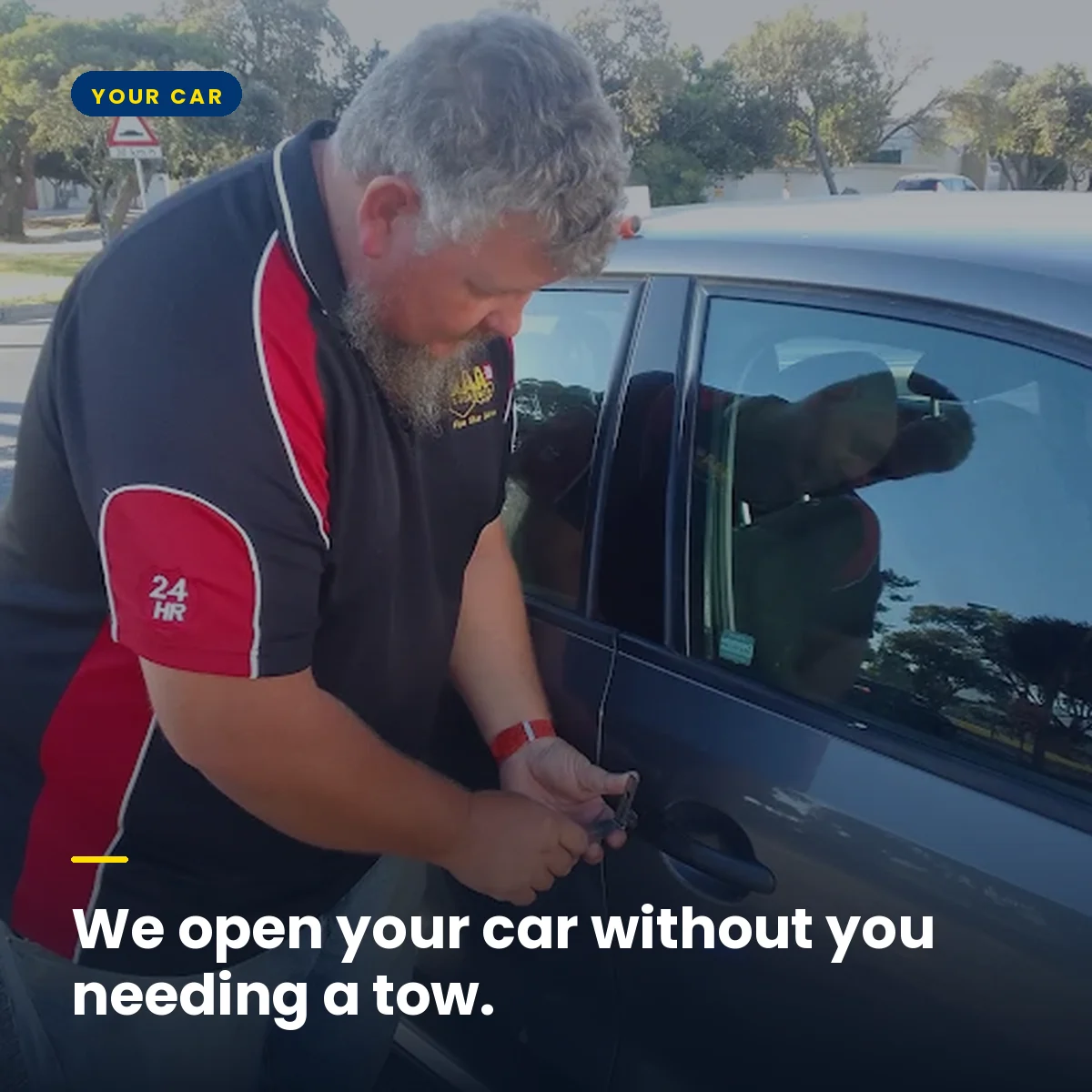 An AAA locksmith opening a locked car door at the roadside