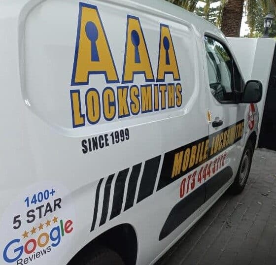 AAA Locksmiths technician in uniform working on a lock