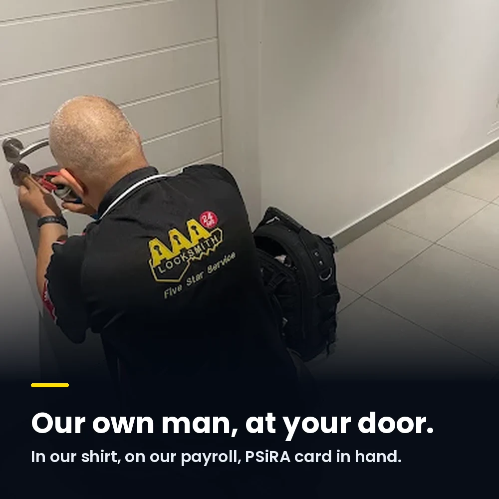 An AAA Locksmiths technician in a branded shirt working on a customer's door lock. Our own man, at your door: in our shirt, on our payroll, PSiRA card in hand.